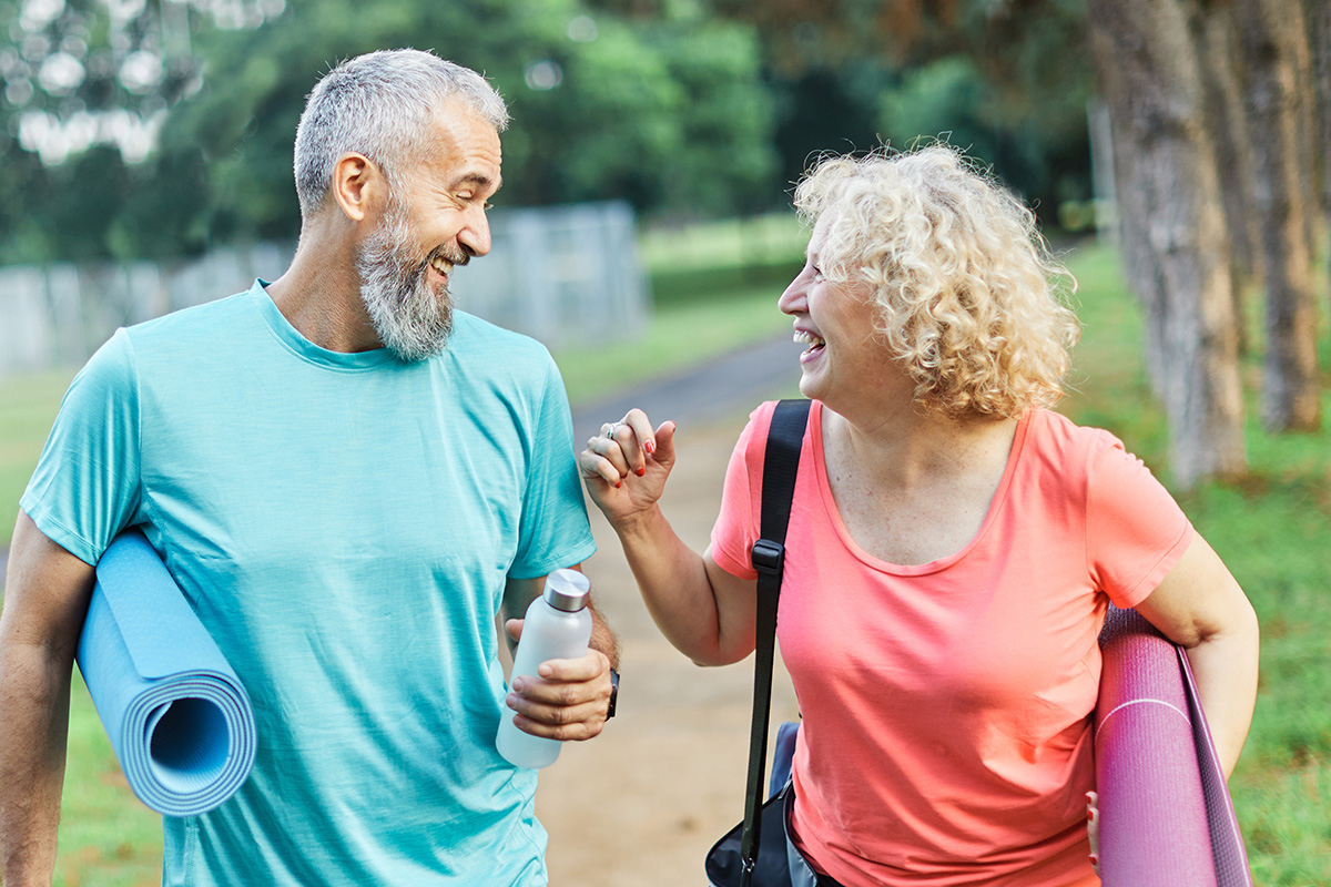 Active ageing seniors walking outdoors with comfort and support